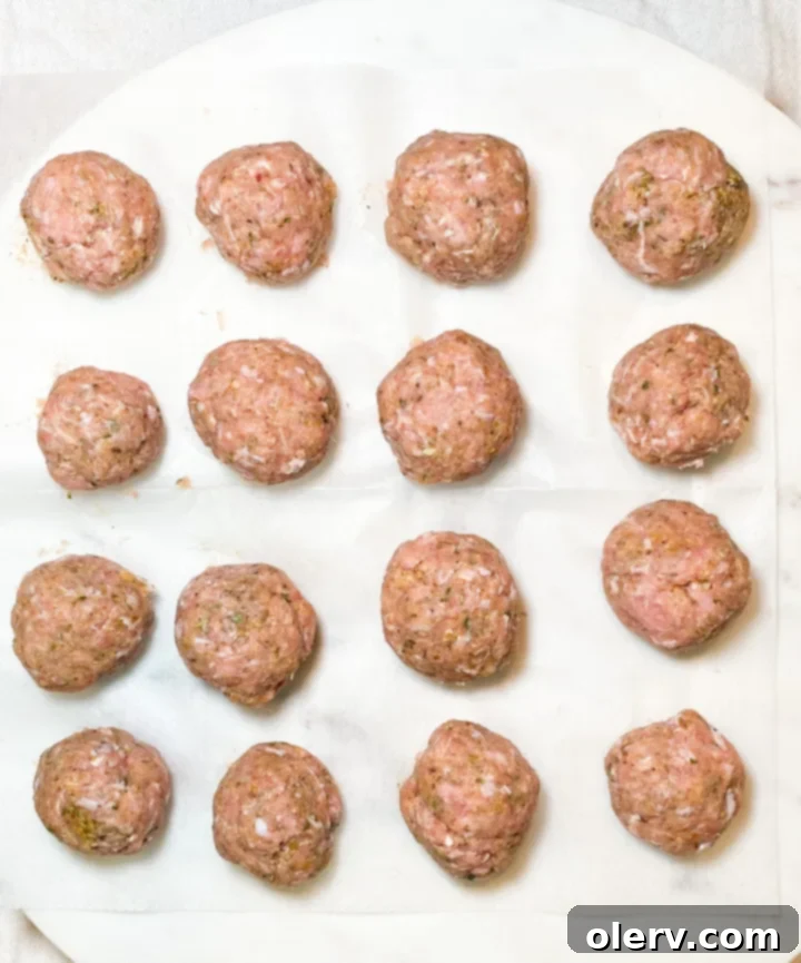 Perfect Air Fryer Turkey Meatballs 4 Mixing ground turkey with breadcrumbs, egg, and seasonings in a bowl.