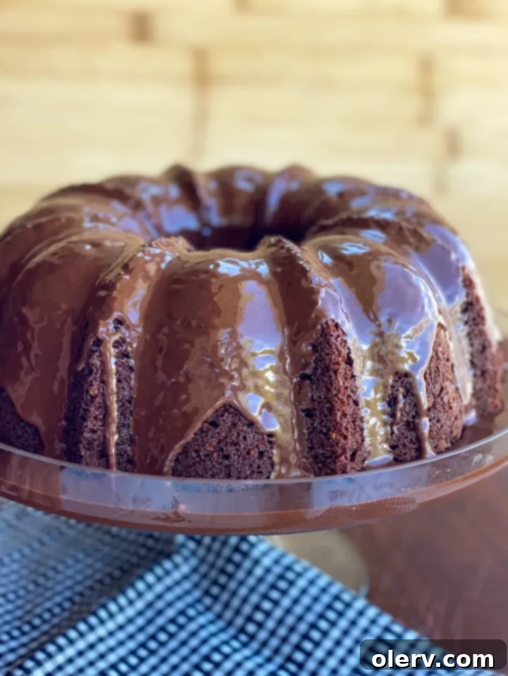 Decadent Chocolate Bundt 5 Ultimate Moist Chocolate Bundt Cake, generously glazed and ready to be served.
