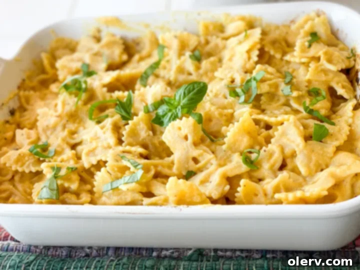 Golden Harvest Pasta 4 Butternut squash, chopped onion, garlic cloves, and a block of feta cheese roasting together in a baking dish