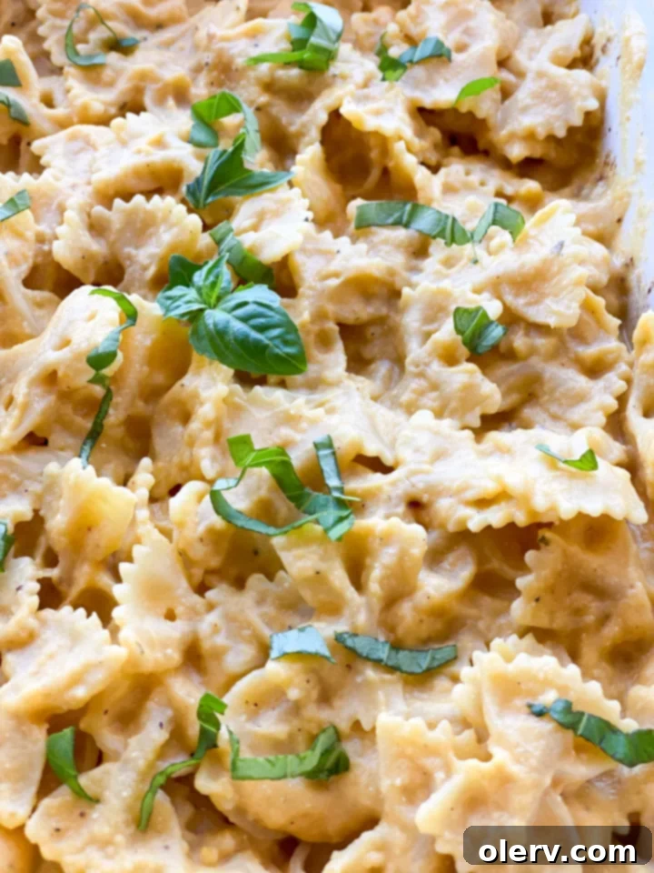 Golden Harvest Pasta 7 A butternut squash being peeled on a wooden cutting board