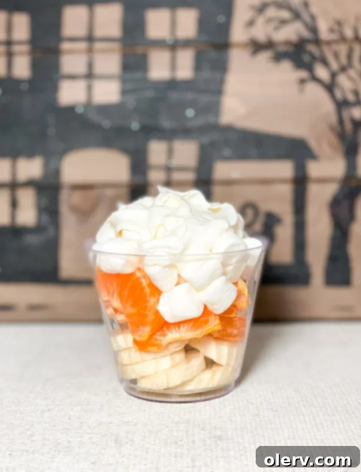 Monster Munchie Cups 7 Candy Corn Fruit Cup with layers of bananas, oranges, and marshmallows