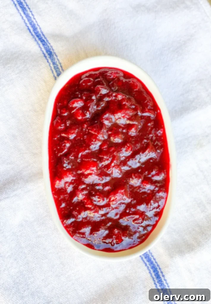 Quick Instant Pot Cranberry Sauce 4 Ingredients for Instant Pot Cranberry Sauce laid out, including cranberries, orange, sugar, and maple syrup
