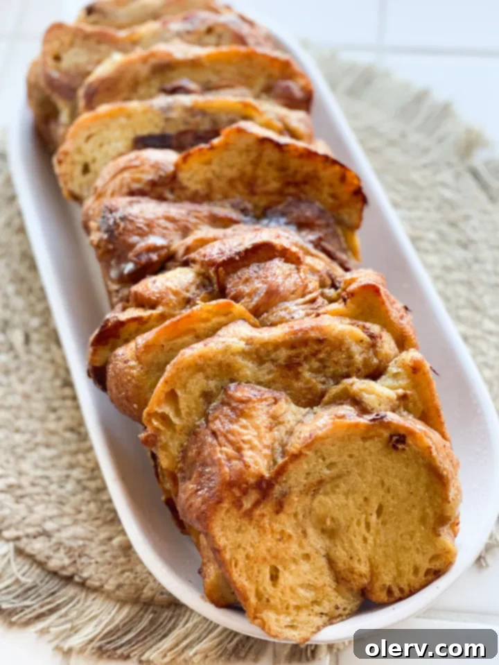 Thick-Cut Cinnamon Bliss French Toast 3 Close-up shot of chunky cinnamon bread slices soaking in a rich egg and milk custard mixture for French toast