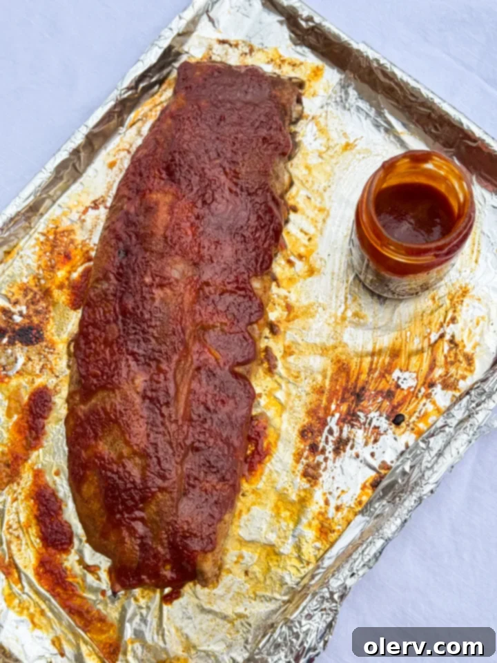 Fall-Off-The-Bone Oven Ribs 2 Perfectly cooked BBQ Ribs in the Oven, coated in a rich sauce