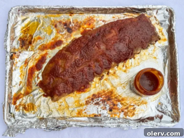 Fall-Off-The-Bone Oven Ribs 6 Homemade BBQ sauce simmering in a saucepan