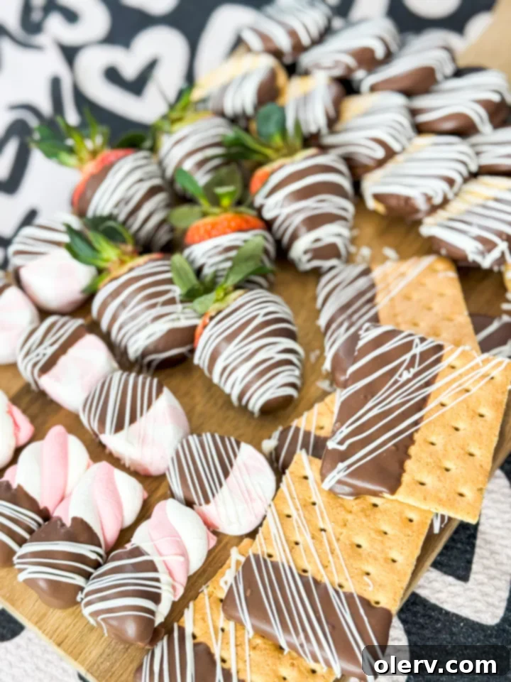 Decadent Chocolate Charcuterie 3 A vibrant selection of chocolate-dipped fruits and cookies arranged artfully on a serving board
