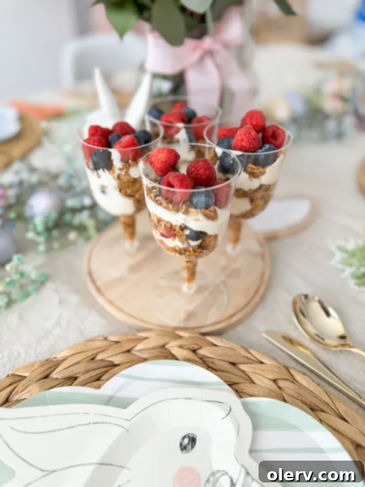 Layered Parfait Perfection 2 Beautifully layered yogurt parfait cups with fresh berries and homemade granola, ready to be served