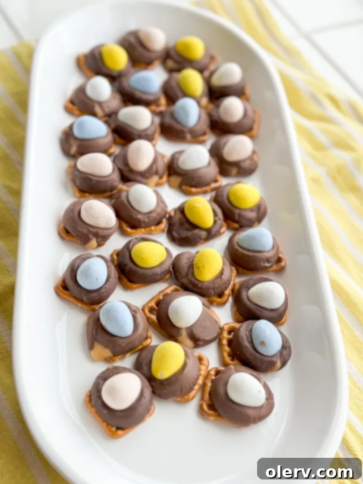 Cadbury Pretzel Buttons 5 Pretzels with Rolos on a baking sheet before baking