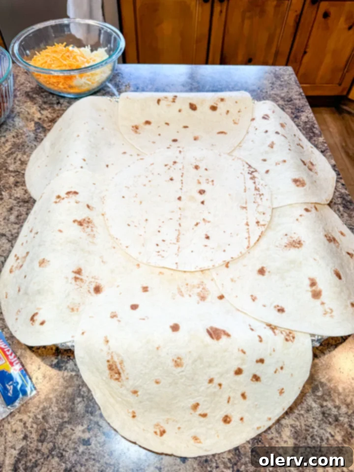 Effortless Oven Quesadillas 6 Layers of cheese, beans, and fajita filling in a sheet pan quesadilla