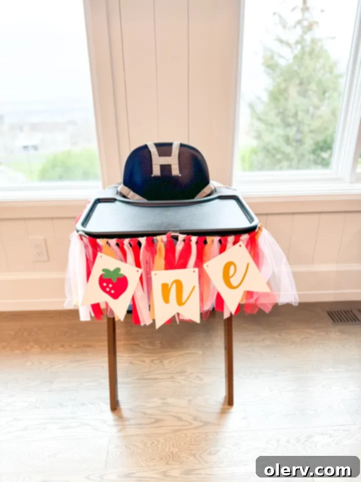 Berry Sweet One 2 Adorable 'Berry First Birthday' themed party setup featuring a baby girl and vibrant decorations.
