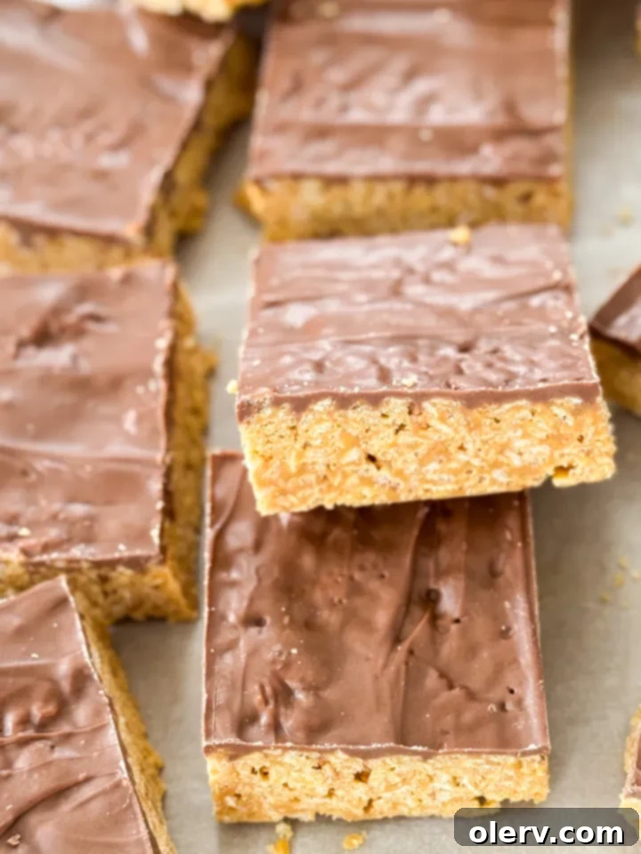 Irresistible No-Bake Scotcheroo Bars 2 Delicious no-bake Scotcheroo bars with peanut butter and chocolate topping, cut into squares.