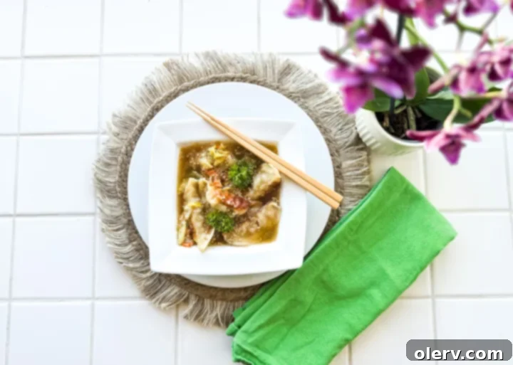 Sizzled Dumpling Soup 4 Assorted ingredients laid out, including fresh ginger, garlic, carrots, and celery, ready for soup preparation.