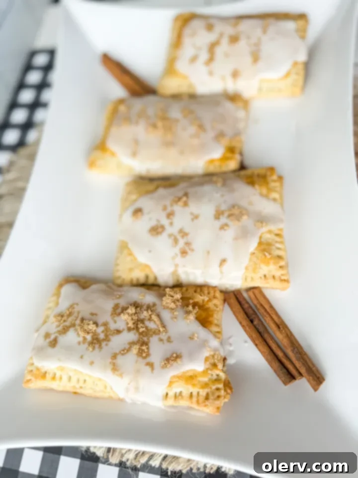 Toasted Brown Sugar Cinnamon Bliss 6 Freshly baked and iced homemade Brown Sugar Cinnamon Poptarts cooling on a wire rack.