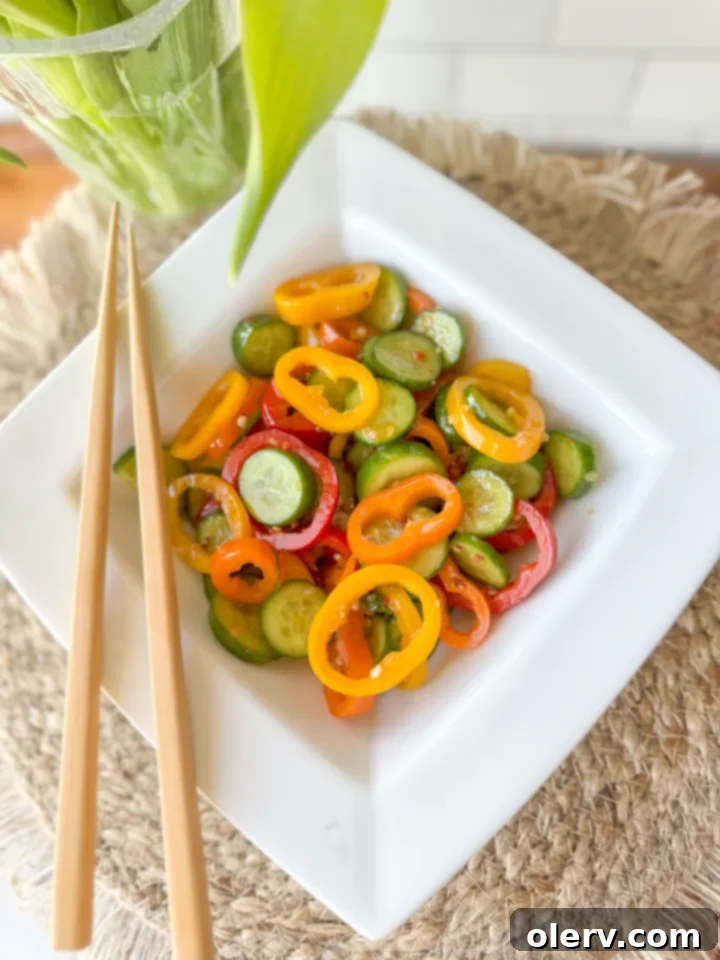 Vibrant Cucumber Pepper Mix 2 Freshly sliced mini cucumbers and bell peppers in a bowl, ready for dressing.