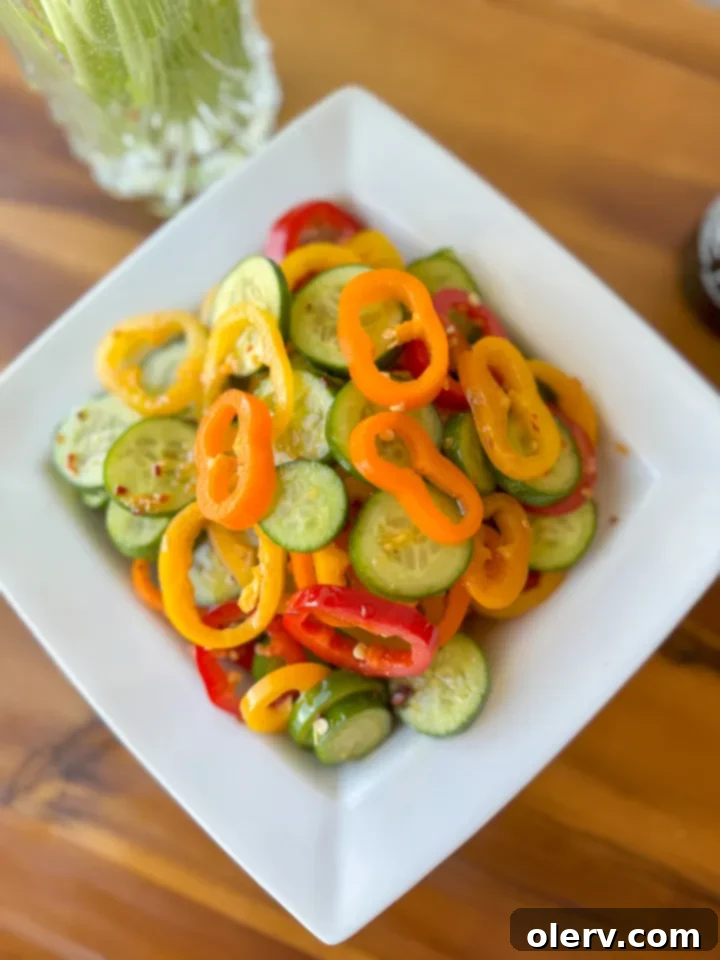 Vibrant Cucumber Pepper Mix 5 A close-up of the homemade ginger sesame dressing in a small bowl with a whisk.