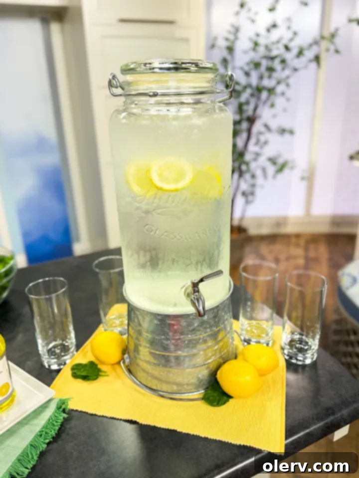 Refreshing Homemade Lemon Water 3 Close-up of a glass of refreshing lemon water with ice and fresh lemon slices, highlighting its crispness.