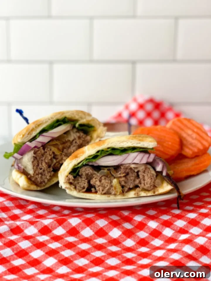 Red Rock Burgers 2 Red Rock Burger with all the fixings, including homemade aioli, caramelized onions, red onion, lettuce, and tomato, served in a warm pita bread pocket.