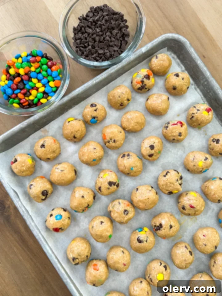 Satisfying Monster Cookie Protein Bites 5 Close-up of protein bite dough in a bowl with spoon