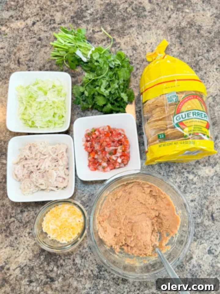 Crispy Chicken Tostadas 4 Close-up of baked chicken tostadas, showing the melted cheese and chicken base before fresh toppings are added.
