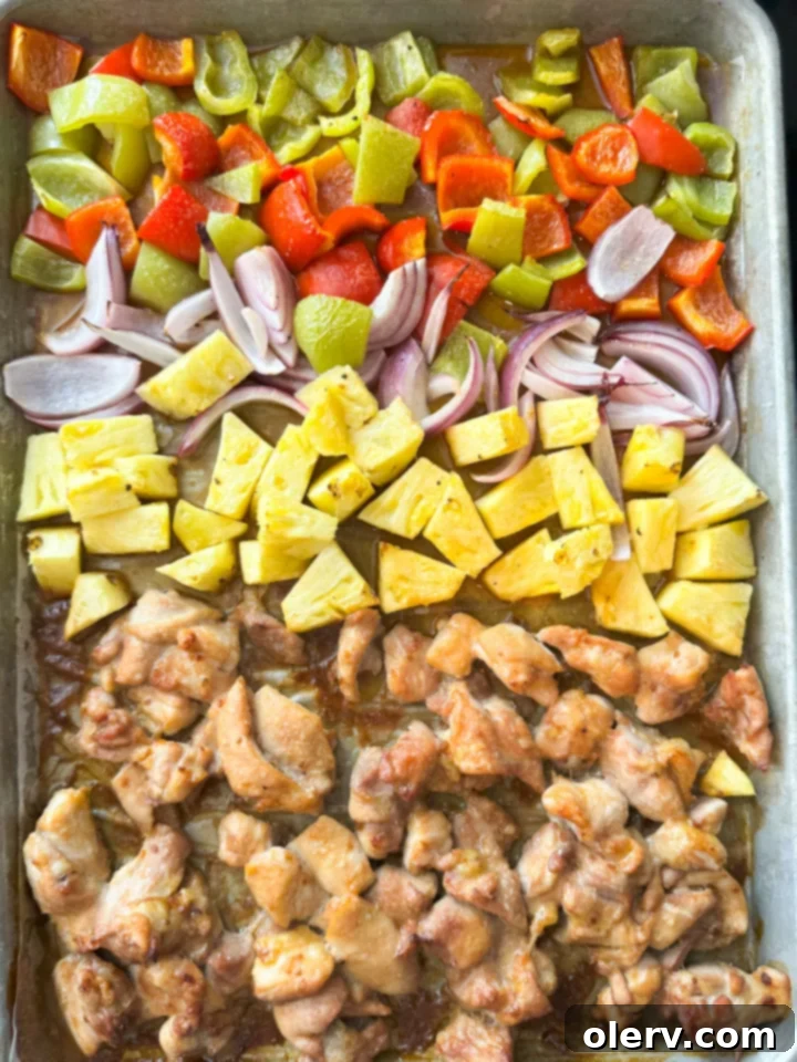 Aloha Chicken 2 Delicious Sheet Pan Hawaiian Chicken served with fresh pineapple and bell peppers.