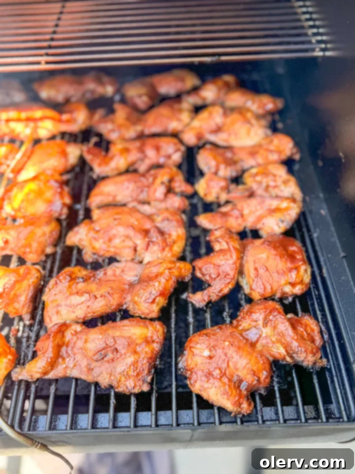 Slow-Smoked BBQ Perfection 3 smoked BBQ chicken thighs on smoker grates