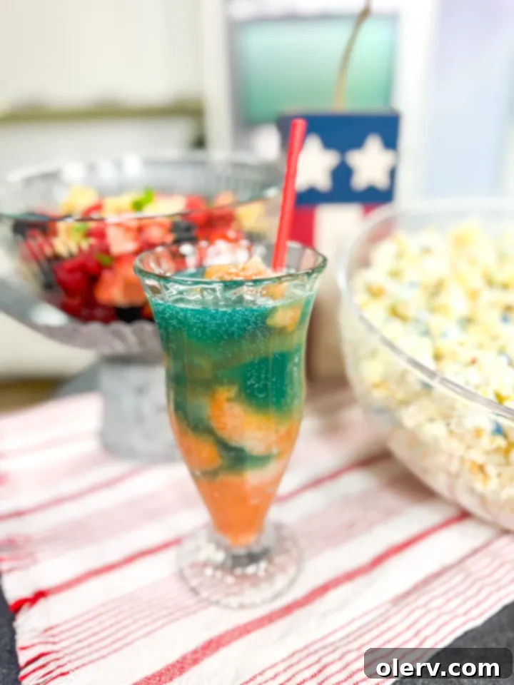 Summer Chill Sip 6 Hand pouring lemon-lime soda over a scoop of frozen summer slush in a clear glass