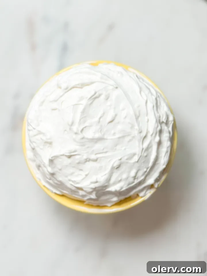 Quick Creamy Fruit Dip 4 The three essential ingredients for the fruit dip: a tub of Cool Whip, a block of cream cheese, and a bag of powdered sugar, neatly laid out on a clean surface.