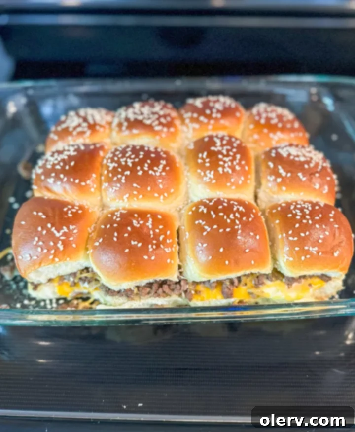 Homestyle Mini Cheeseburgers 2 Perfectly baked All-American Cheeseburger Sliders arranged on a baking sheet, ready to serve.