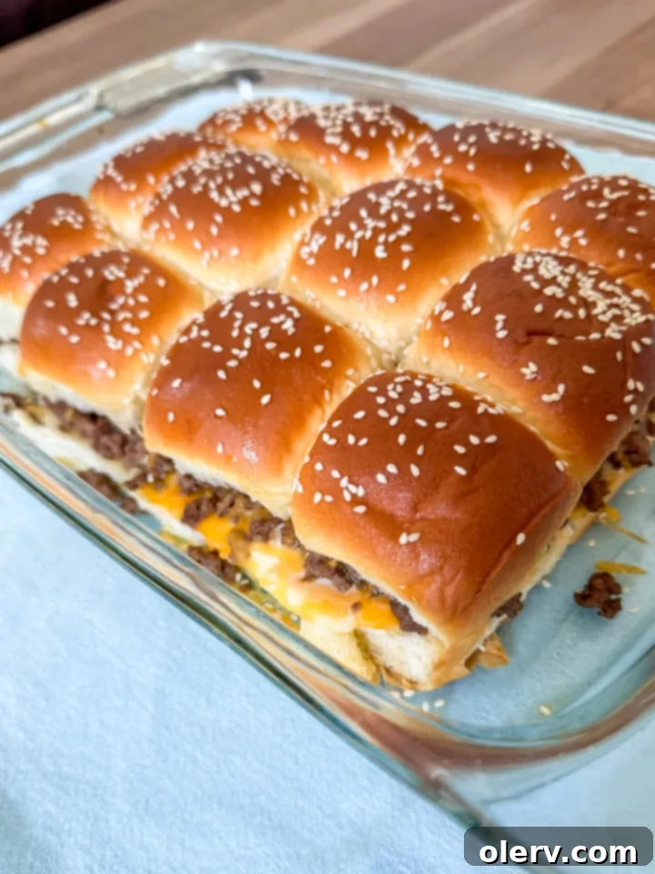 Homestyle Mini Cheeseburgers 6 Unbaked All-American Cheeseburger Sliders assembled on a baking sheet, ready for the oven.