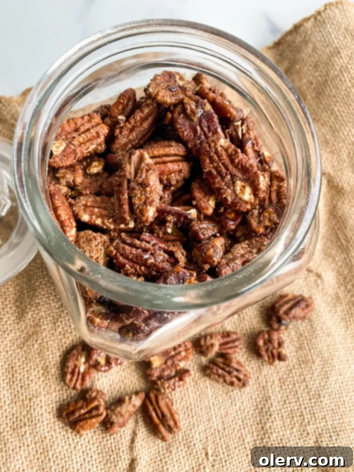 Irresistible Candied Pecans 2 Close-up of freshly made candied pecans, showing their glistening, sugary coating and rich brown color.