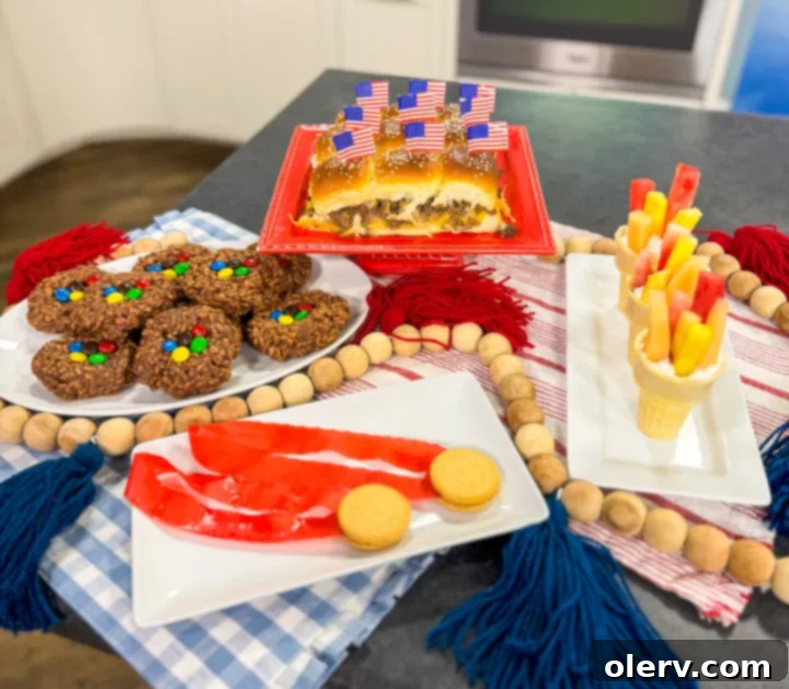 4 Winning Olympic Party Bites 2 A vibrant spread of Olympic-themed party food, featuring sliders, fruit torches, and gold medal treats.