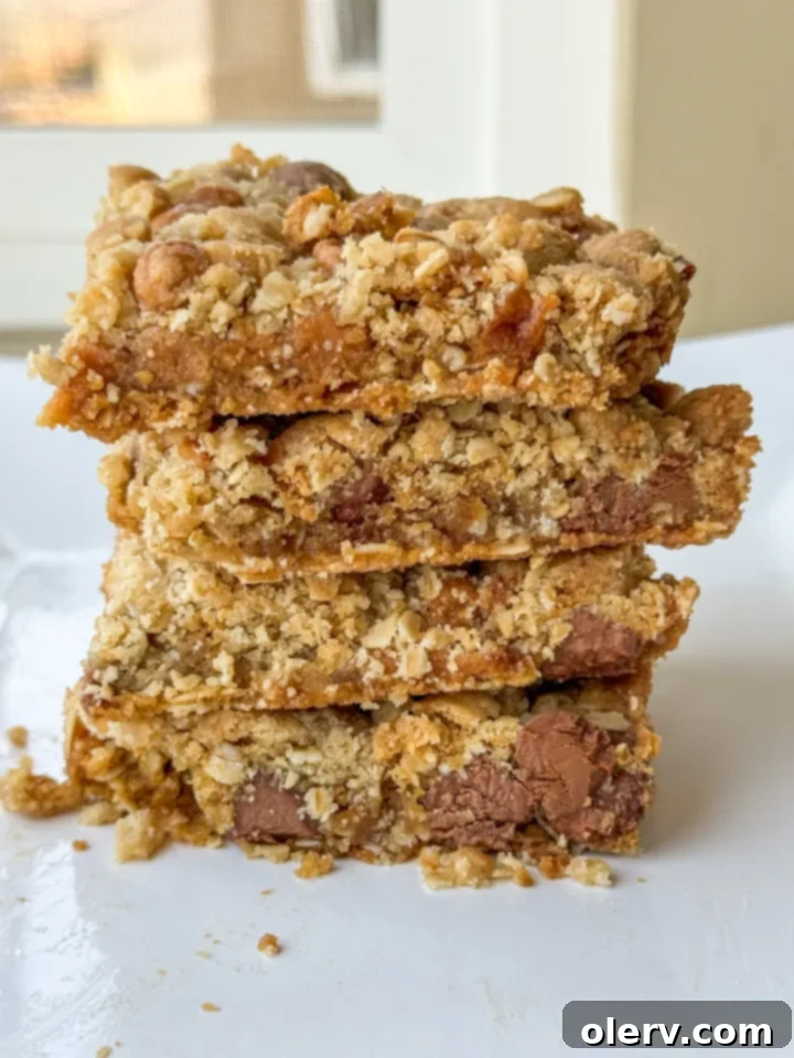 Gooey Caramel Chocolate Chip Cookie Bars 2 Delicious Caramel Chocolate Chip Bar Cookies stacked on a plate, showing the layers.