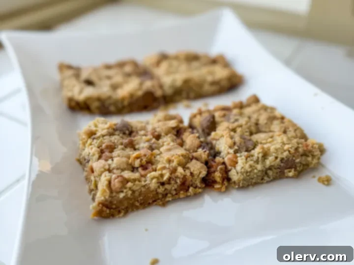 Gooey Caramel Chocolate Chip Cookie Bars 5 A large sheet pan filled with the Caramel Chocolate Chip Bar Cookie dough, ready for baking.