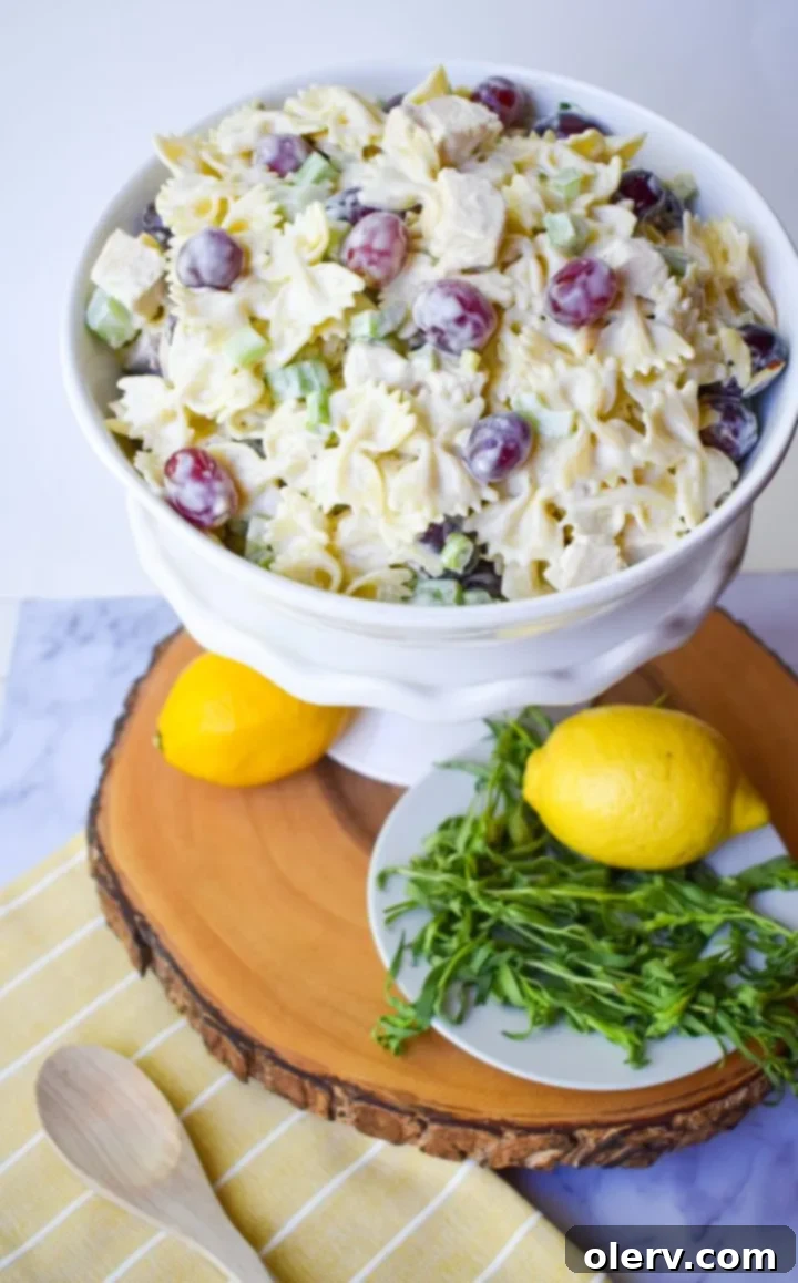 Bright Lemon Tarragon Pasta Medley 3 Close-up of Lemon Tarragon Pasta Salad in a white bowl, showing the creamy dressing coating the ingredients.