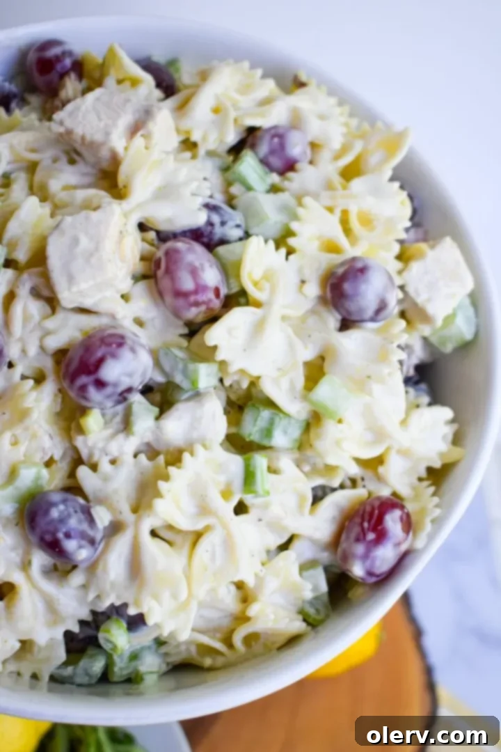 Bright Lemon Tarragon Pasta Medley 7 A large serving bowl filled with the prepared Lemon Tarragon Pasta Salad, ready to be enjoyed.