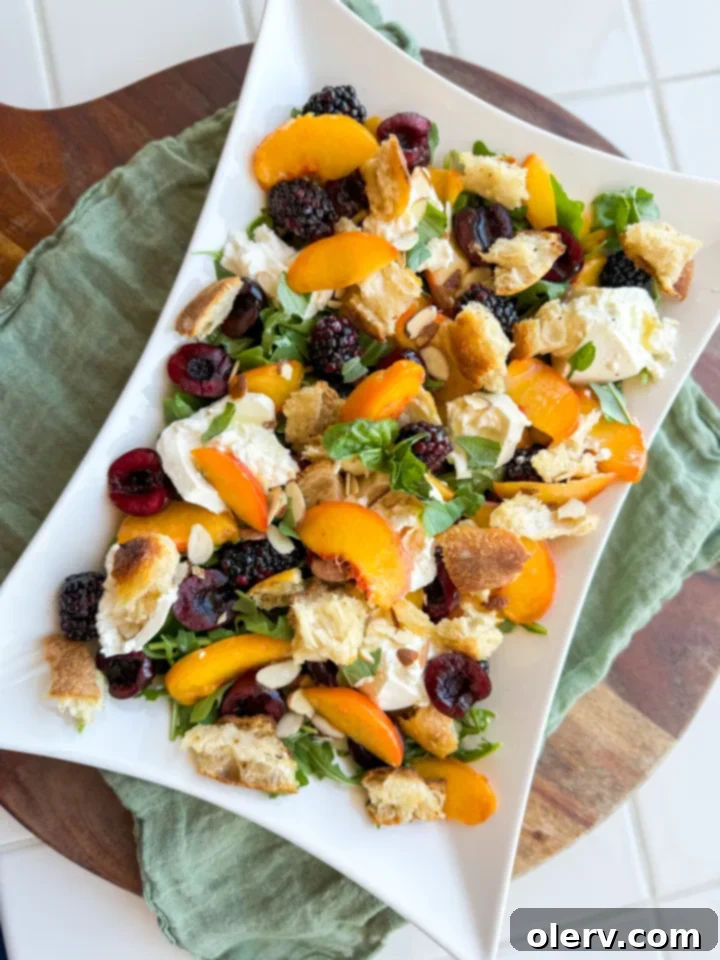 Sun-Kissed Peach & Burrata Delight 5 Assortment of fresh ingredients for a peach and burrata salad, including peaches, berries, burrata, basil, and a baguette, arranged on a wooden board.