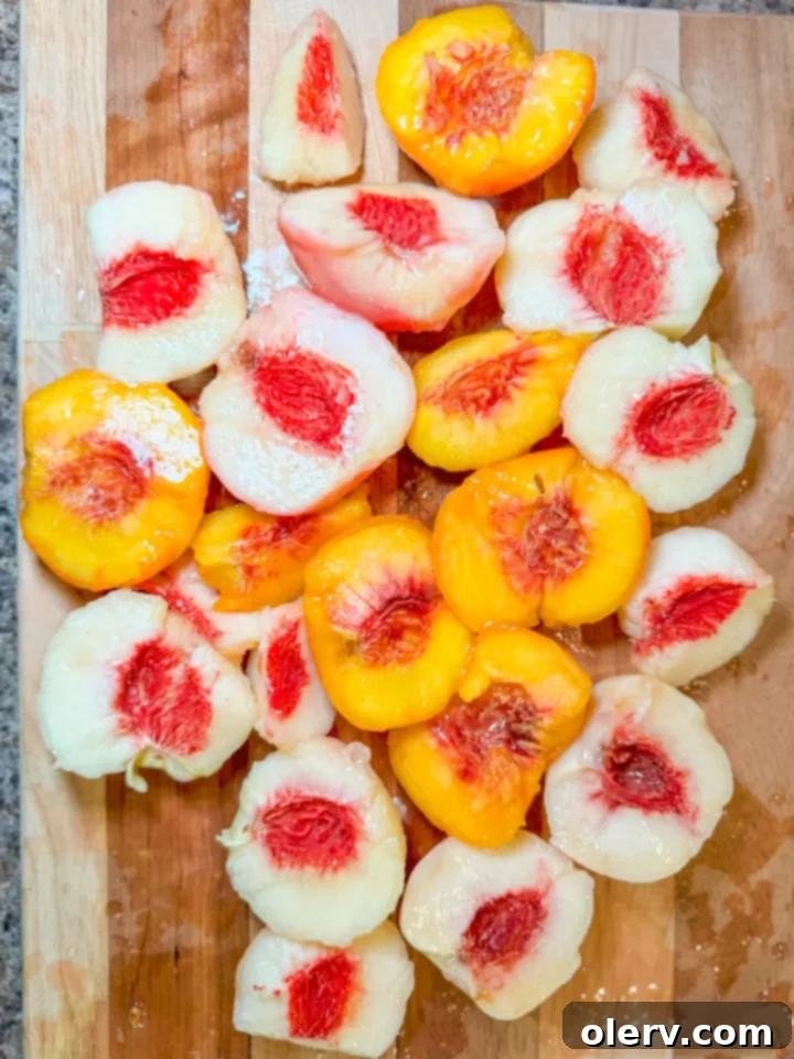 Creamy No-Bake Peach Delight 4 Ingredients for no-bake peach cream pie laid out on a kitchen counter: Biscoff cookies, fresh peaches, condensed milk, lemon, heavy cream, powdered sugar, and vanilla extract.