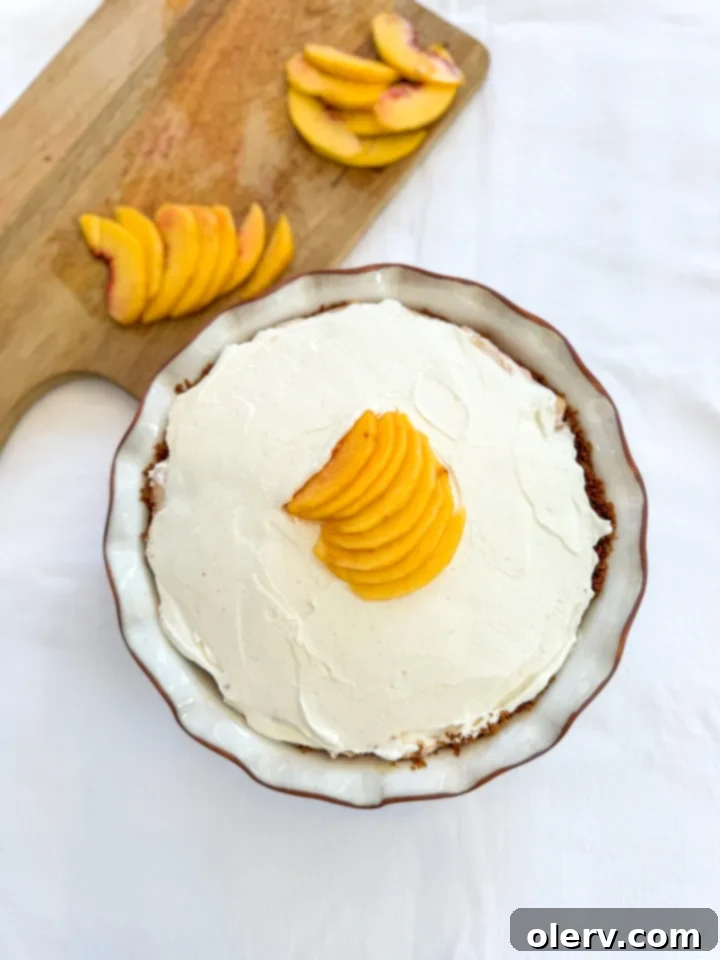 No-Bake Peach Cream Pie ready to be sliced, perfect for dessert.