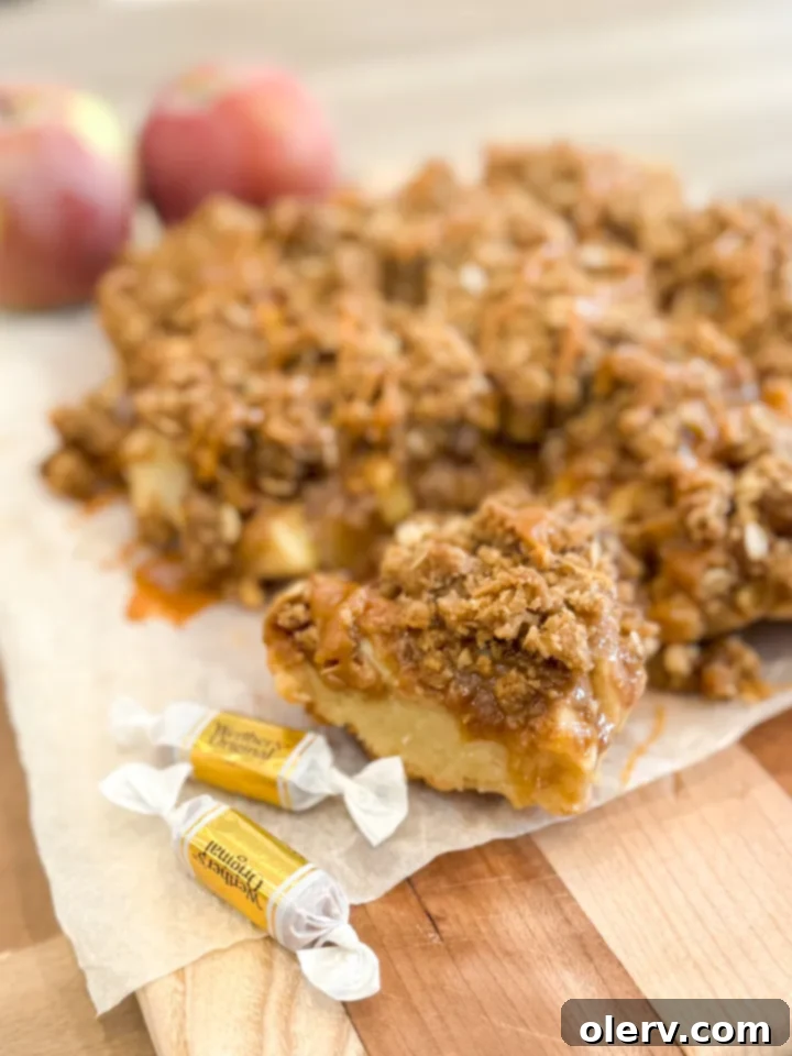 Golden Caramel Apple Delights 3 Close-up of baked caramel apple bars, showcasing the crumble topping and golden-brown edges.