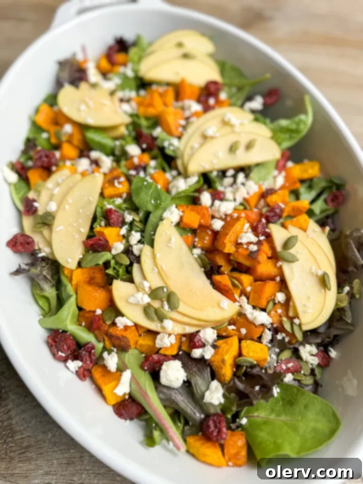 Crisp Apple Harvest Salad 4 Hand arranging freshly sliced Honeycrisp apples on a salad