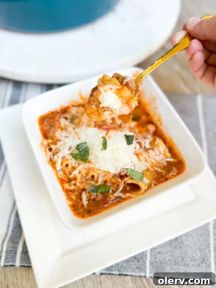 Ultimate Lasagna Soup 2 A bowl of rich, hearty lasagna soup with melted cheese and fresh basil