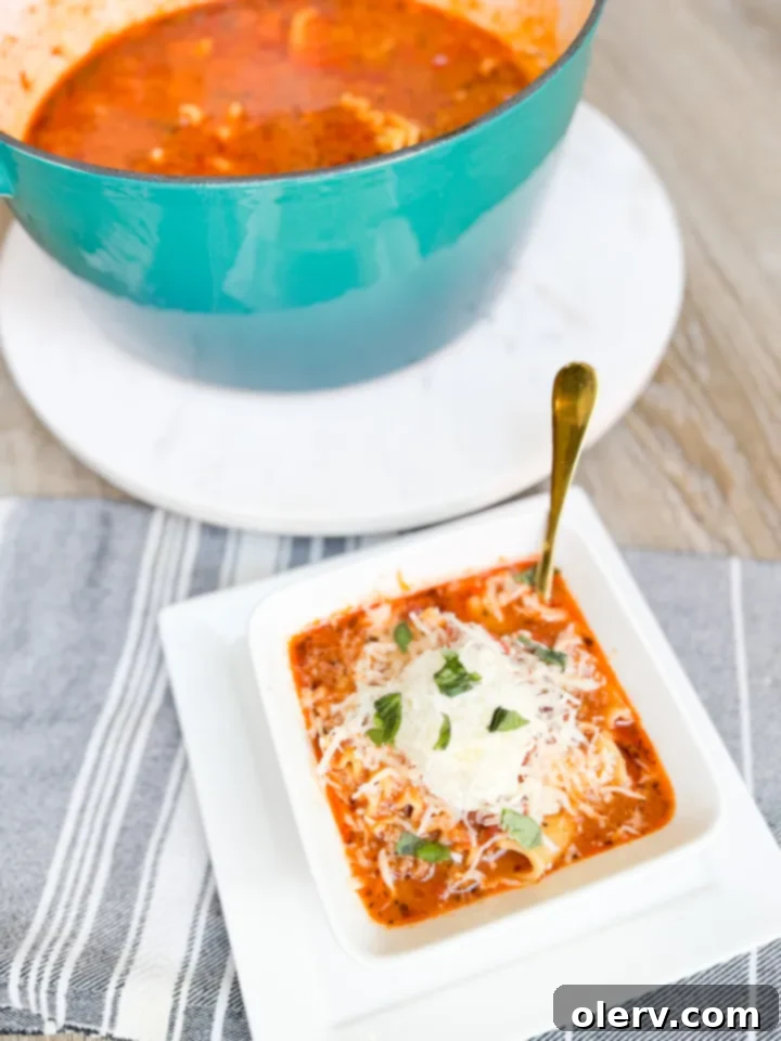 Ultimate Lasagna Soup 5 A large pot of simmering lasagna soup, with noodles visible in the rich tomato broth