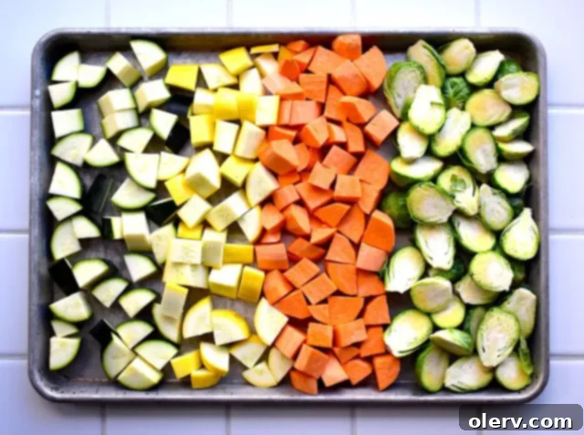 Baked Eggs with Garden Vegetables 2 Assortment of vibrant vegetables and chicken apple sausage ready for roasting