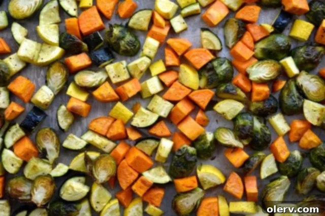 Baked Eggs with Garden Vegetables 3 Colorful sheet pan dinner with roasted vegetables, sausage, and a fried egg