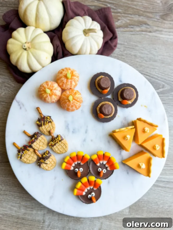 Mini Thanksgiving Delights 2 Assortment of festive tiny Thanksgiving treats, including pumpkin cuties and chocolate turkeys, on a wooden board.