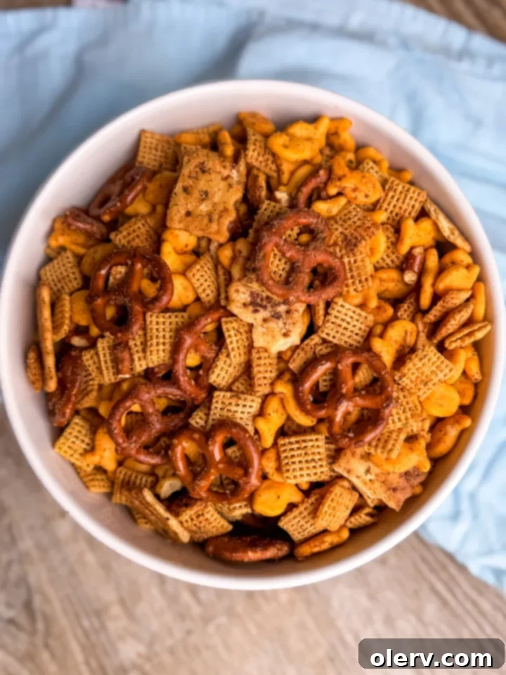 Raw ingredients for Ranch Chex Mix, including Chex cereal, pretzels, Goldfish crackers, and Chicken in a Biscuit crackers, laid out before mixing.