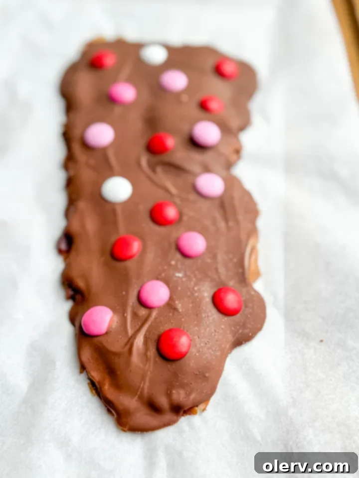 Girl Dinner Perfected 7 Delicious Date Bark topped with almond butter, melted chocolate, and flaky sea salt, a perfect sweet treat.