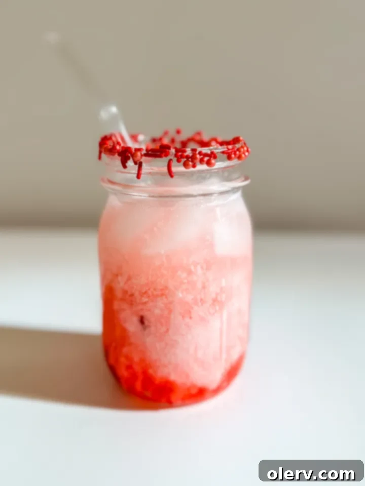 Girl Dinner Perfected 8 A vibrant pink Dirty Shirley drink garnished with a maraschino cherry and a fun straw.