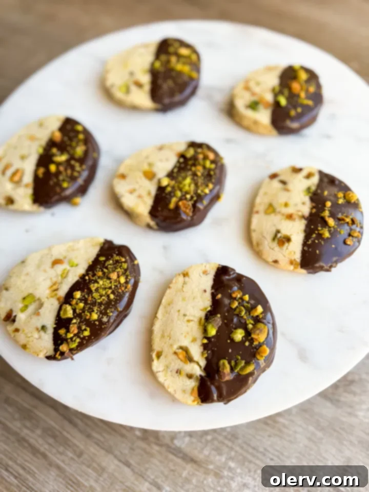 Buttery Pistachio Shortbread Cookies 3 Close-up of freshly baked pistachio shortbread cookies on a cooling rack, showing their golden edges.