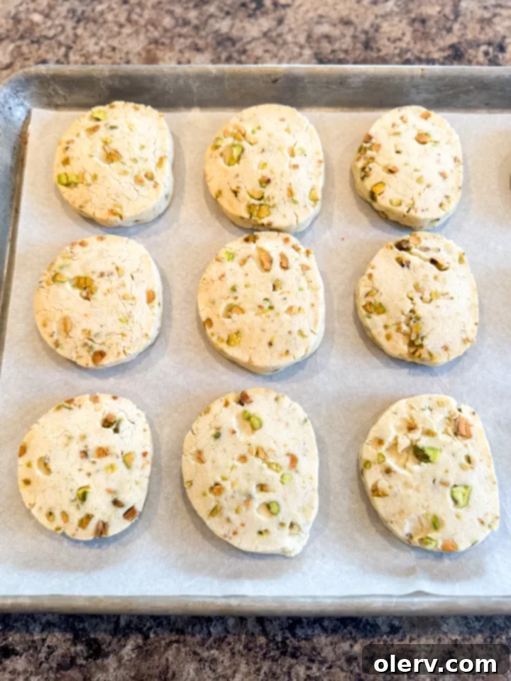 Buttery Pistachio Shortbread Cookies 4 Ingredients for pistachio shortbread cookies laid out on a table, including butter, sugar, flour, pistachios, and chocolate.